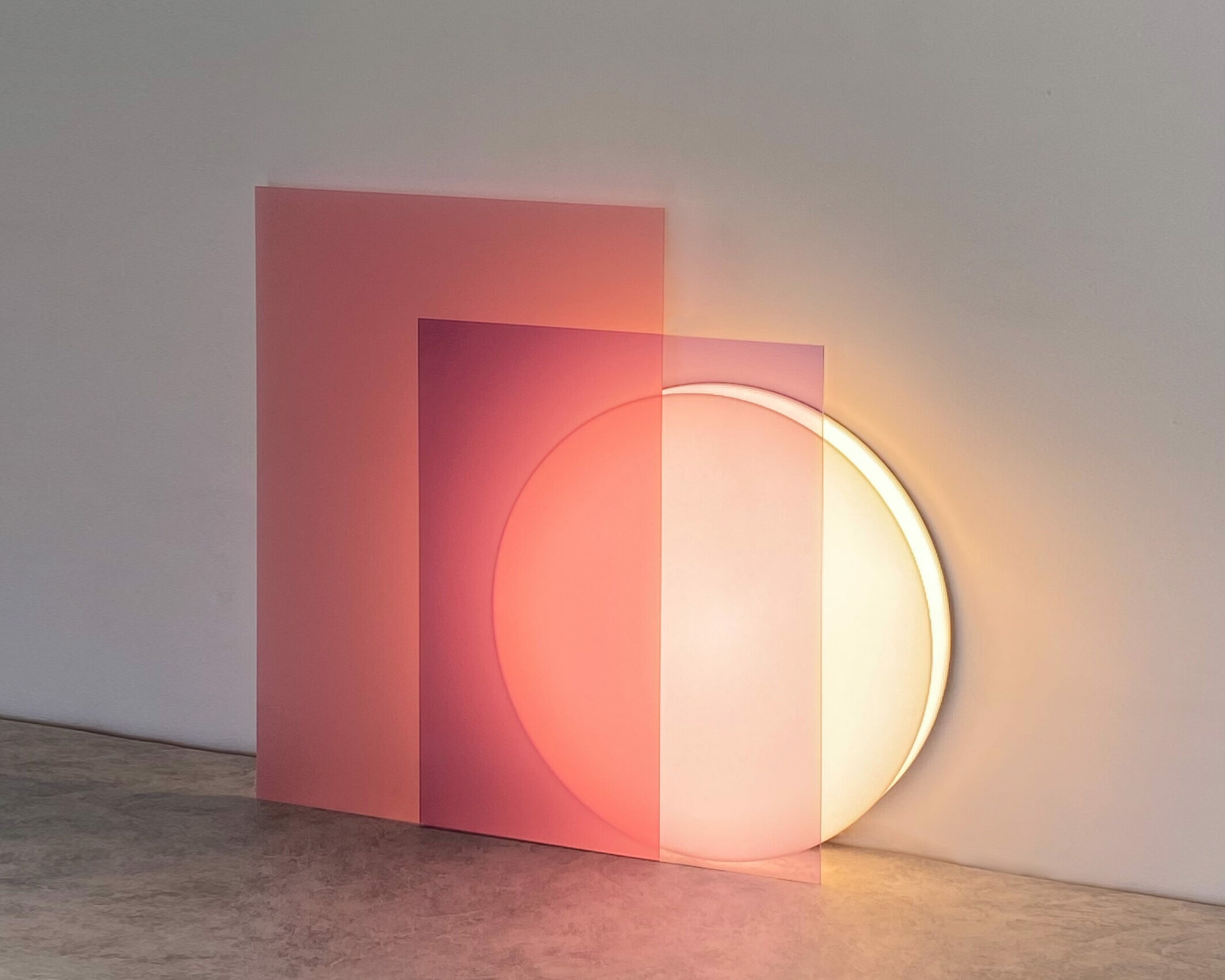 A sleek and modern floor lamp, called Lune, with a curved white base and a thin neon light