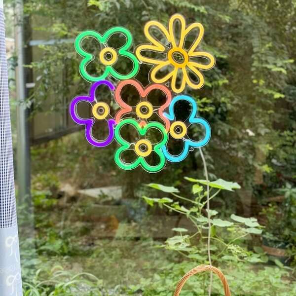 Daisies multi color neon sign by the window